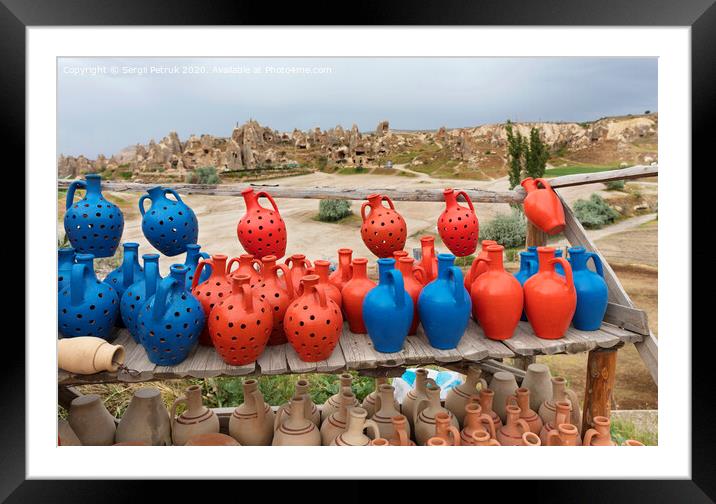 The multi-colored clay pots of desires stand on a wooden table in Cappadocia. Framed Mounted Print by Sergii Petruk