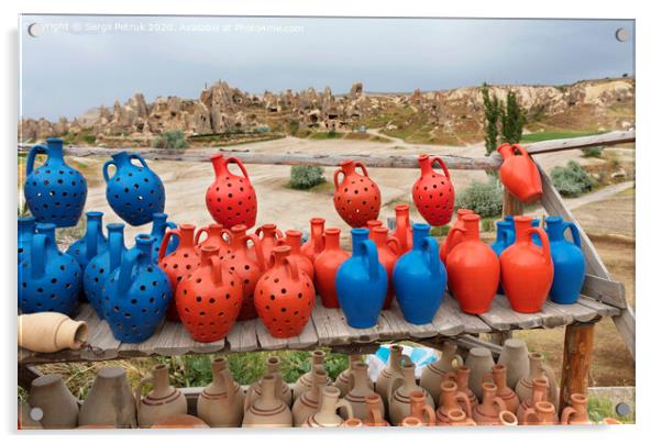 The multi-colored clay pots of desires stand on a wooden table in Cappadocia. Acrylic by Sergii Petruk