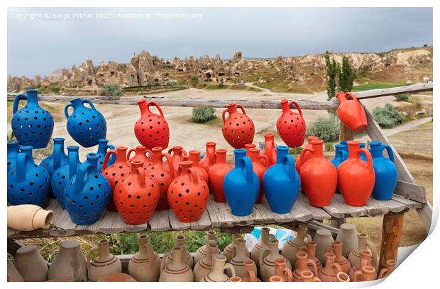 The multi-colored clay pots of desires stand on a wooden table in Cappadocia. Print by Sergii Petruk