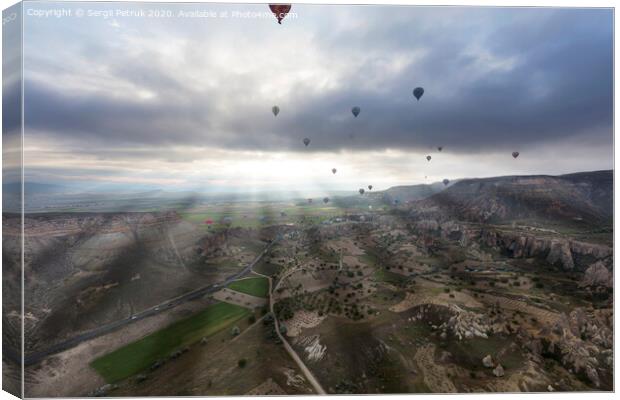Balloons fly over the valleys in Cappadocia Canvas Print by Sergii Petruk