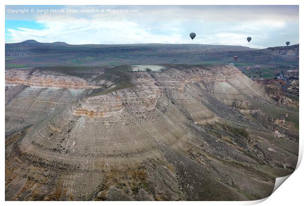 Balloons fly over the valleys in Cappadocia Print by Sergii Petruk