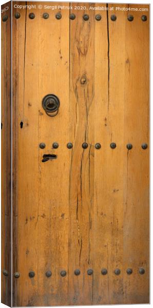 old wooden door with wrought iron rivets Canvas Print by Sergii Petruk