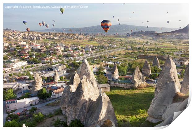 Dozens of balloons fly over the valleys in Cappadocia Print by Sergii Petruk