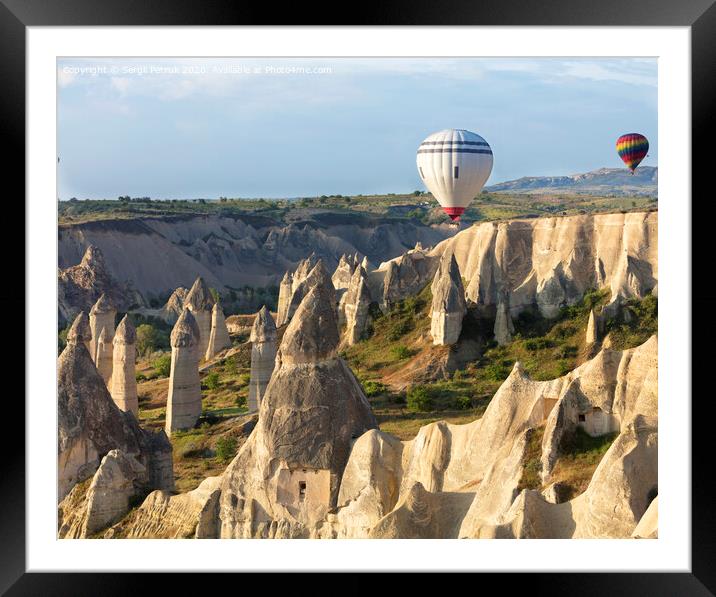 A balloon is flying over the valley in Cappadocia Framed Mounted Print by Sergii Petruk