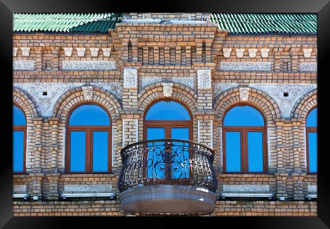 The wooden windows of the old architecture building reflect the blue clear sky Framed Print by Sergii Petruk