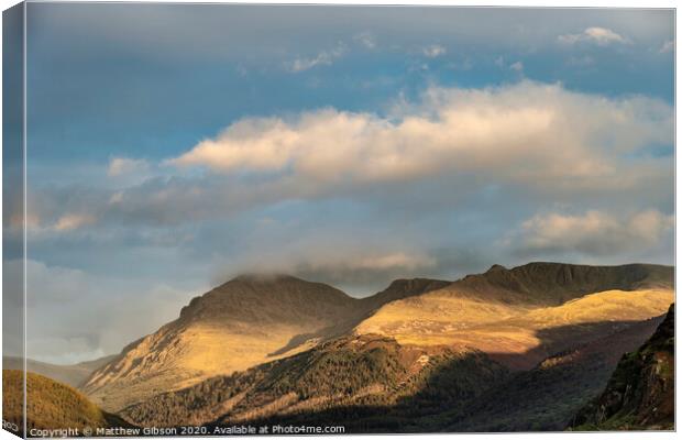 Stunning landscape image looking across Ennerdale Water in the English Lake District towards the peaks of Scoat Fell and Pillar during a glorious Summer sunset Canvas Print by Matthew Gibson