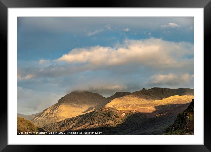 Stunning landscape image looking across Ennerdale Water in the English Lake District towards the peaks of Scoat Fell and Pillar during a glorious Summer sunset Framed Mounted Print by Matthew Gibson