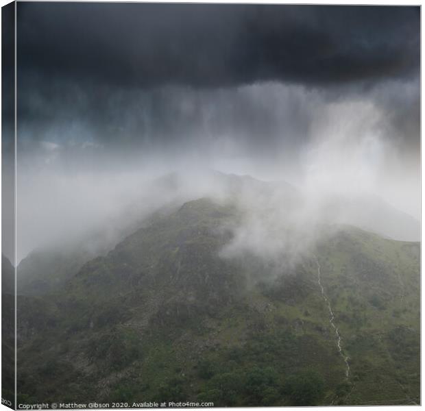 Dramatic landscape image of storm clouds hanging over Snowdonia mountain range with heavy rainfall in Autumn with misty weather Canvas Print by Matthew Gibson
