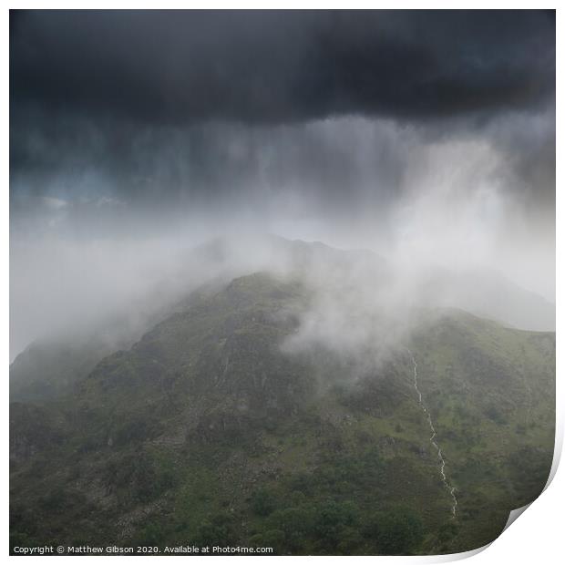 Dramatic landscape image of storm clouds hanging over Snowdonia mountain range with heavy rainfall in Autumn with misty weather Print by Matthew Gibson