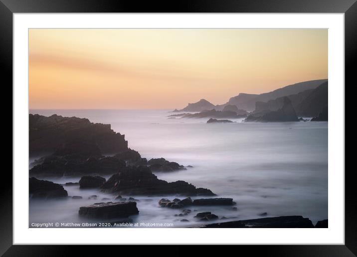 Beautiful long exposure landscape image of sea over rocks during vibrant sunset Framed Mounted Print by Matthew Gibson