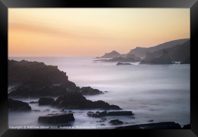 Beautiful long exposure landscape image of sea over rocks during vibrant sunset Framed Print by Matthew Gibson