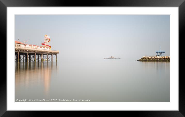 Minimalist fine art landscape image of colorful pier in juxtaposition with old derelict pier in background Framed Mounted Print by Matthew Gibson