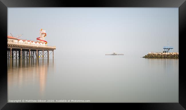 Minimalist fine art landscape image of colorful pier in juxtaposition with old derelict pier in background Framed Print by Matthew Gibson