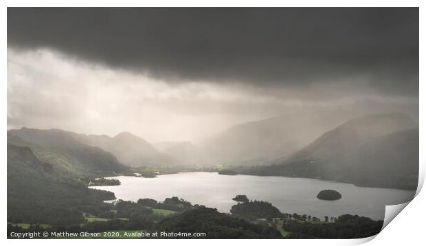 Stunning epic landscape image across Derwentwater valley with falling rain drifting across the mountains causing pokcets of light and dark across the countryside Print by Matthew Gibson
