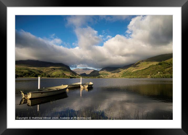 Landscape image of rowing boats on Llyn Nantlle in Snowdonia at sunset Framed Mounted Print by Matthew Gibson