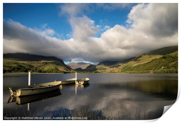 Landscape image of rowing boats on Llyn Nantlle in Snowdonia at sunset Print by Matthew Gibson