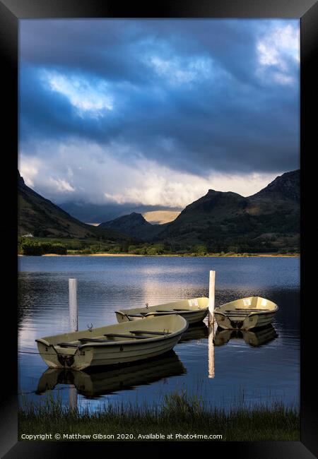 Stunning dramatic stormy sky formations over breathtaking mountain lake landscape with rowing boats in foreground Framed Print by Matthew Gibson