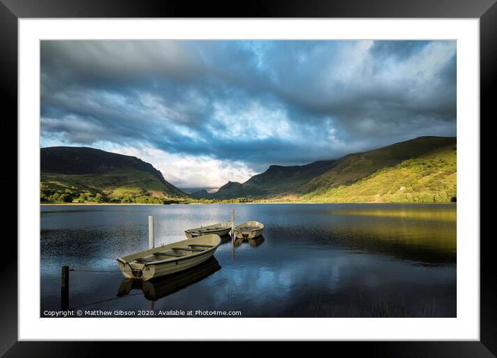 Landscape image of rowing boats on Llyn Nantlle in Snowdonia at sunset Framed Mounted Print by Matthew Gibson