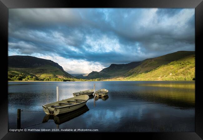 Landscape image of rowing boats on Llyn Nantlle in Snowdonia at sunset Framed Print by Matthew Gibson