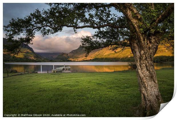 Landscape image of rowing boats on Llyn Nantlle in Snowdonia at sunset Print by Matthew Gibson