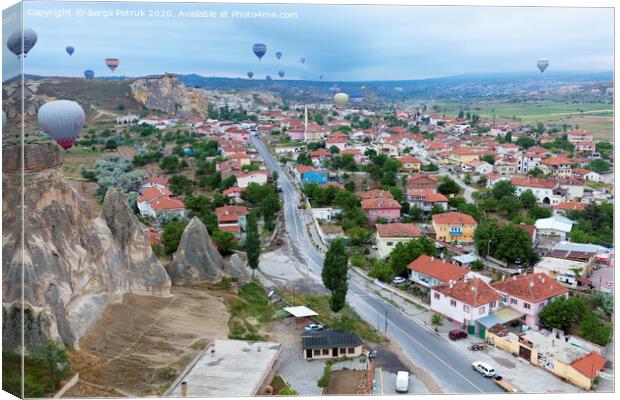 Dozens of balloons fly over the valleys in Cappadocia Canvas Print by Sergii Petruk