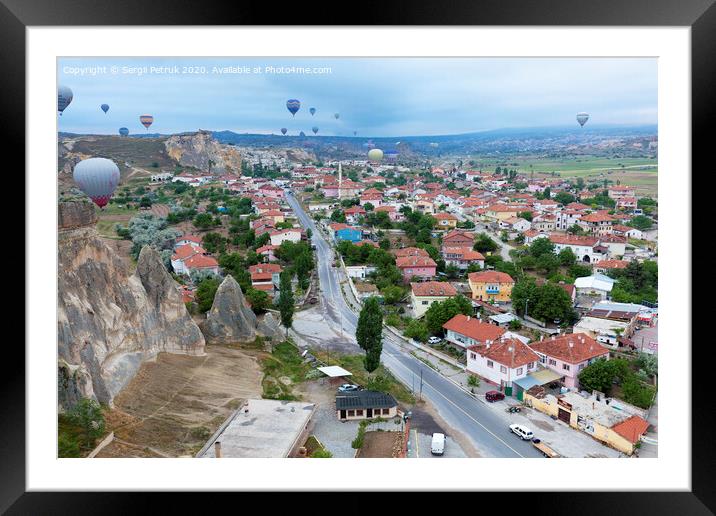 Dozens of balloons fly over the valleys in Cappadocia Framed Mounted Print by Sergii Petruk