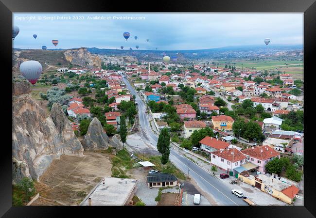 Dozens of balloons fly over the valleys in Cappadocia Framed Print by Sergii Petruk