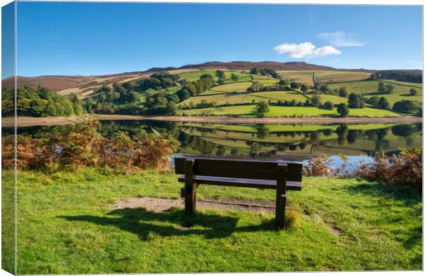 A wooden bench with views of Ladybower reservoir Canvas Print by Andrew Kearton