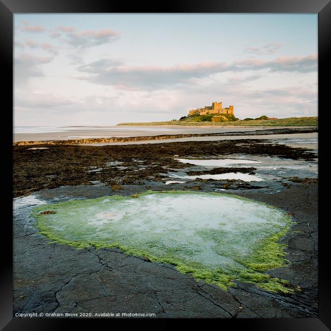 Bamburgh Castle Heart Rock Pool At Sunset Framed Print by Graham Binns