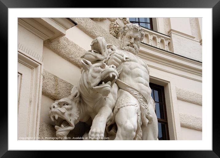 Antique scene of fight between man and mythical creatures on The Hofburg palace in Vienna Framed Mounted Print by M. J. Photography