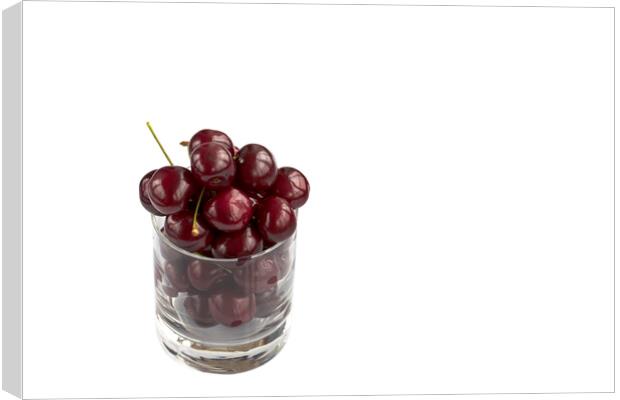 Red cherry in a transparent glass isolated on a white background Canvas Print by Sergii Petruk