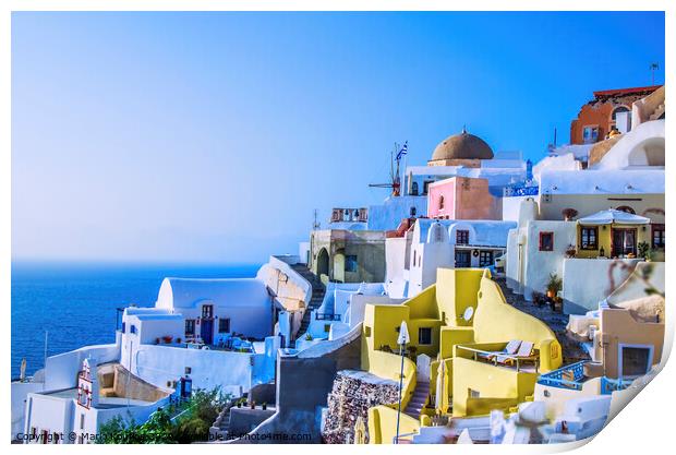 At dusk the sun bathes the traditional and colorful Greek houses in the town of Oia Print by Mario Koufios
