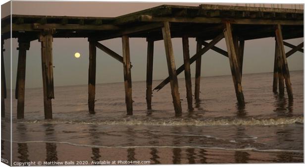 Moonrise behnd a pier Canvas Print by Matthew Balls