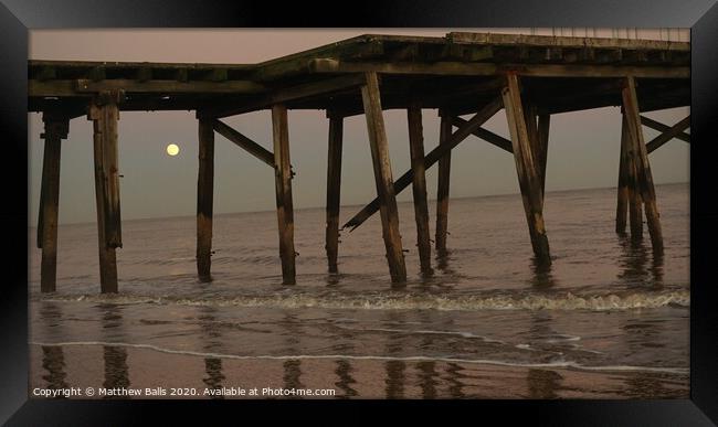 Moonrise behnd a pier Framed Print by Matthew Balls