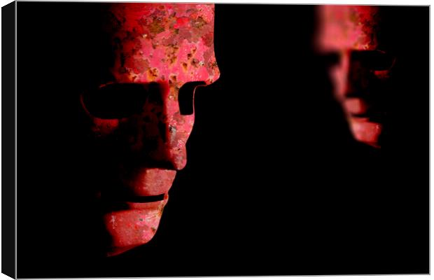 Two red rusting old decaying robot faces Canvas Print by Simon Bratt LRPS