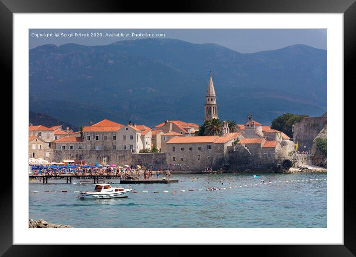 View of the beach and the old town of Budva in Montenegro against the background of blue-green mountains. August 2018. Framed Mounted Print by Sergii Petruk