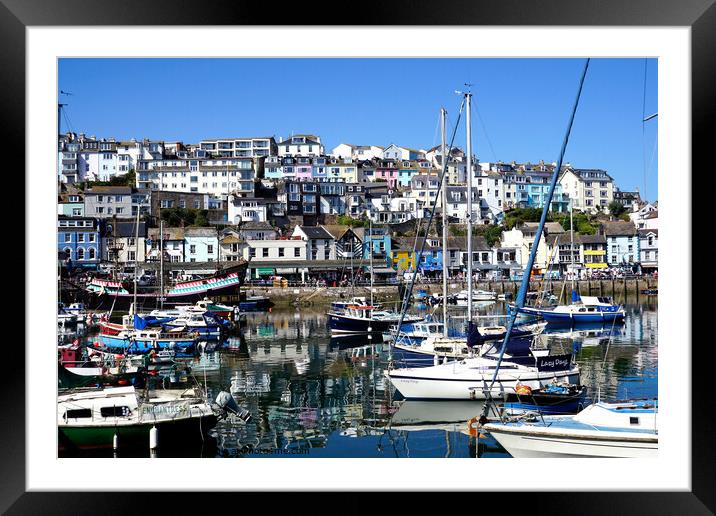 The inner harbour with reflections at Brixham in Devon. Framed Mounted Print by john hill