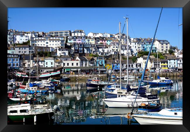 The inner harbour with reflections at Brixham in Devon. Framed Print by john hill