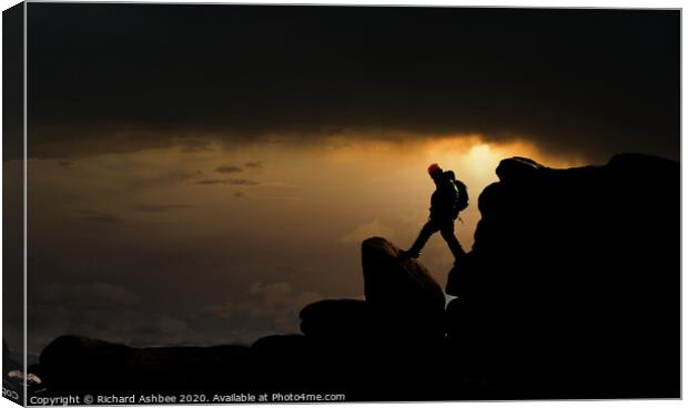 Climber descends steep rocky outcrop Canvas Print by Richard Ashbee