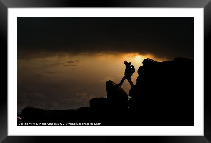 Climber descends steep rocky outcrop Framed Mounted Print by Richard Ashbee