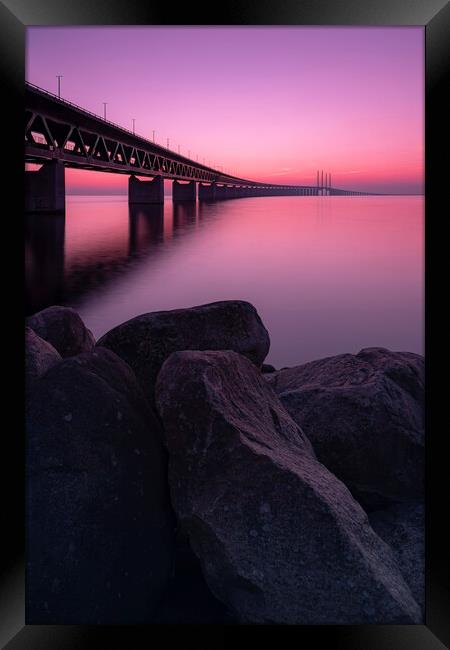 Oresunds Bridge and Rocky Shore at Sunset Framed Print by Antony McAulay