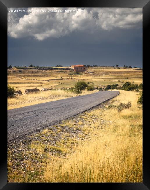 Road Across a Countryside Scene Under Stormy clouds Framed Print by Pere Sanz