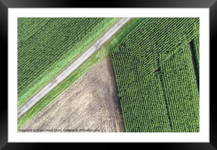 Aerial photograph of a harvested arable land next to a maize field Framed Mounted Print by Frank Heinz