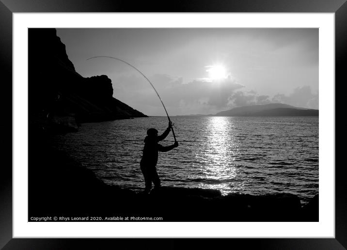 Young man fishing with feathers for mackerel B+W Framed Mounted Print by Rhys Leonard