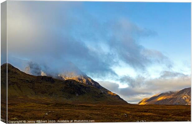 Glencoe mountain with low lying clouds and early morning light Canvas Print by Jenny Hibbert