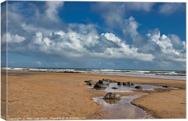 Rocks on a Sandy Beach Canvas Print by Mike Dale