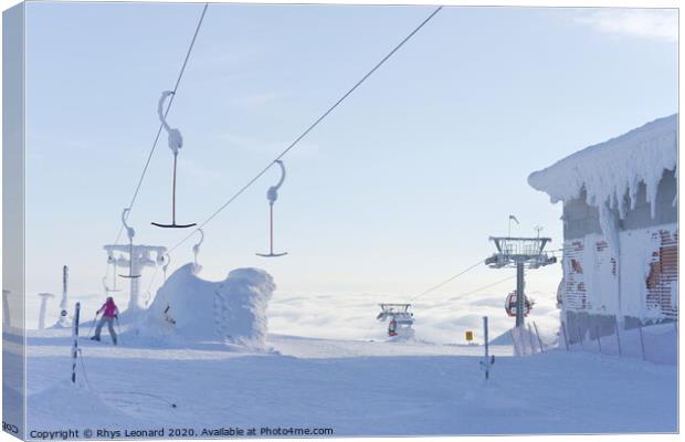 At the top of ski lifts rising above the clouds in Finland. Canvas Print by Rhys Leonard