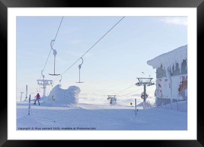 At the top of ski lifts rising above the clouds in Finland. Framed Mounted Print by Rhys Leonard