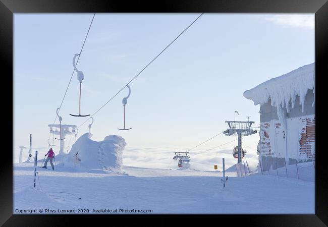 At the top of ski lifts rising above the clouds in Finland. Framed Print by Rhys Leonard
