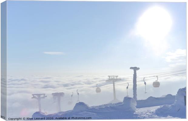 T-bar and gondola lifts emerge through the clouds into the sun Canvas Print by Rhys Leonard